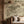 Dog Tales wallpaper by Victoria Sanders in green, a toile of dogs in the countryside behind a sofa in a living room