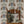Pair of Cats wallpaper by Annika Reed in brown, pairs of cats and vases on a living room wall