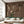 Birdsong By the Lake wallpaper by Dami and Em Design in brown, birds and blossom by a lake behind a sofa in a living room