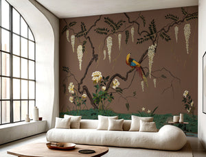 Birdsong By the Lake wallpaper by Dami and Em Design in brown, birds and blossom by a lake behind a sofa in a living room