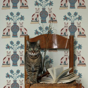 Pair of Cats wallpaper by Annika Reed in blue and cream, pairs of cats and vases in a living room