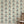 Pair of Cats wallpaper by Annika Reed in blue and cream, pairs of cats and vases behind a sofa in a living room