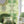 Amalfi wallpaper by Liberty James Studio in green and pink, a marbled kaleidoscope design in a living room