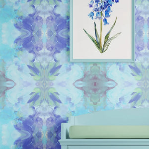 Amalfi wallpaper by Liberty James Studio in blue and pink, a marbled kaleidoscope design in a styled room setting
