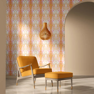 Bel Air Blossom wallpaper by Liberty James Studio in apricot, a mirrored blossom design behind a sofa in a living room