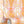 Bel Air Blossom wallpaper by Liberty James Studio in apricot, partly unrolled roll showing a mirrored blossom design