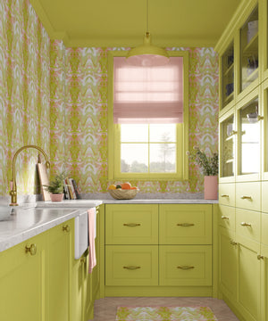 Bel Air Blossom wallpaper by Liberty James Studio in yellow-green, a mirrored blossom design behind bar stools