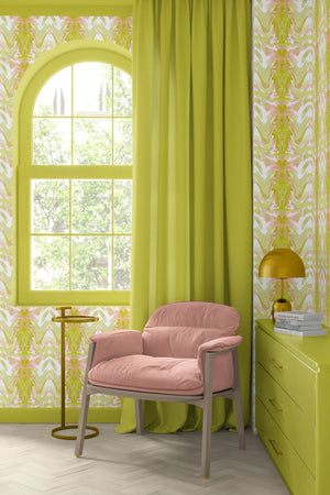 Bel Air Blossom wallpaper by Liberty James Studio in yellow-green, a mirrored blossom design behind a sofa in a living room