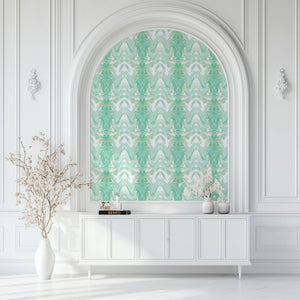 Bel Air Blossom wallpaper by Liberty James Studio in mint green, a mirrored blossom design in a styled room setting