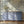 Dog Tales wallpaper by Victoria Sanders in blue and cream, a toile of dogs in the countryside above a sideboard