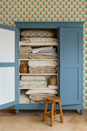 Dahlia wallpaper by Annika Reed in green, dahlia flowers above a sideboard
