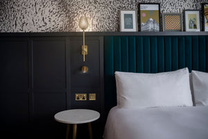 Disorder in Stasis Type II vinyl wallpaper by The Monkey Puzzle Tree in black and white in a bedroom