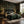 Eden wallpaper by Deus ex Gardenia in black, lush leaves and fruit in a bedroom