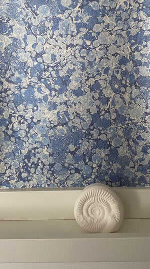 Ditzy wallpaper by House of Amitié in blue, roll showing fine hand-marbled pattern