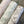 Flourish wallpaper by House of Amitié in green, roll showing flowing scrolls