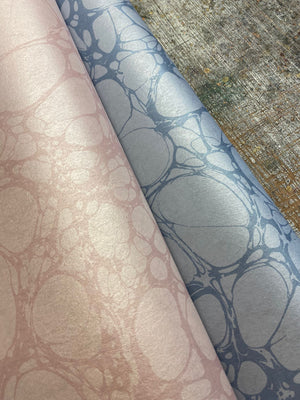 Moucheté wallpaper by House of Amitié in pink, roll showing soft marbled spots