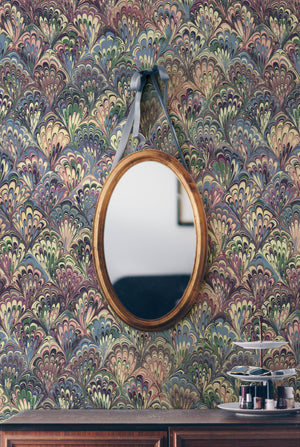 Serpentine wallpaper by House of Amitié in pink and blue, peacock-feather marbling in a styled room setting
