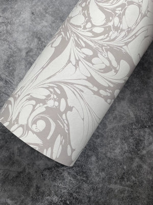 Flourish wallpaper by House of Amitié in silver, roll showing flowing scrolls