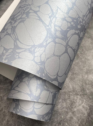 Moucheté wallpaper by House of Amitié in blue, roll showing soft marbled spots
