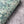 Ditzy wallpaper by House of Amitié in green, partly unrolled roll showing fine hand-marbled pattern