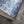 Ditzy wallpaper by House of Amitié in blue, partly unrolled roll showing fine hand-marbled pattern