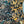 Serpentine wallpaper by House of Amitié in blue and black, close-up of peacock-feather marbling