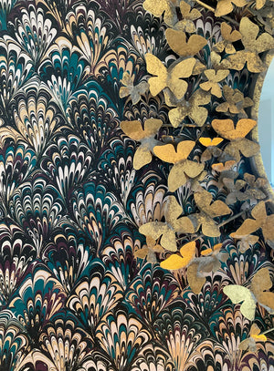 Serpentine wallpaper by House of Amitié in blue and black, close-up of peacock-feather marbling