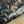 Serpentine wallpaper by House of Amitié in blue and black, sample roll showing peacock-feather marbling