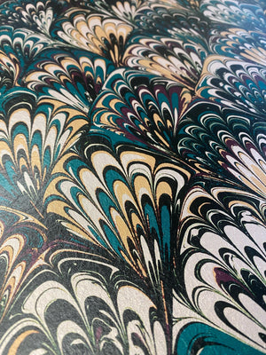 Serpentine wallpaper by House of Amitié in blue and black, full repeat of peacock-feather marbling