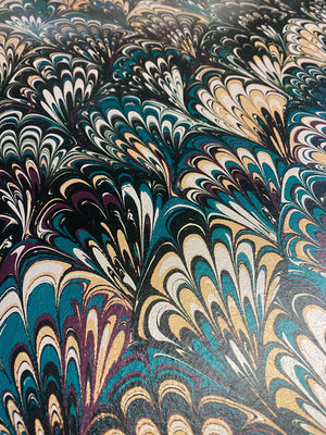 Serpentine wallpaper by House of Amitié in blue and black, pattern sample of peacock-feather marbling