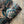 Serpentine wallpaper by House of Amitié in blue and black, roll showing peacock-feather marbling