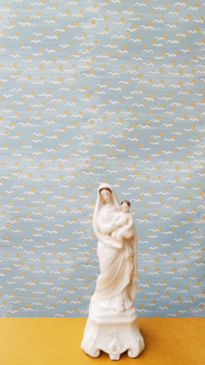Malo wallpaper by Claire de Quénetain in yellow, scattered tiny motifs above a sideboard