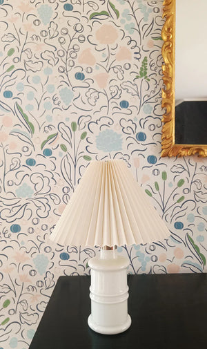 Beatrice wallpaper by Claire de Quénetain in blue, a hand-painted floral design above a sideboard