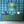 Motif wallpaper by Tatie Lou in blue, geometric pyramids above a sideboard