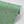 Agnes wallpaper by Tatie Lou in green and pink, partly unrolled roll showing swirling wave lines