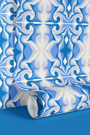 Marco Island wallpaper by Liberty James Studio in blue, partly unrolled roll showing a scrolling damask design