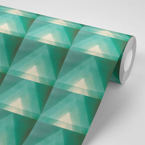 Motif wallpaper by Tatie Lou in green, partly unrolled roll showing geometric pyramids