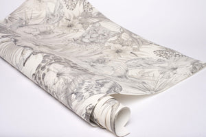 Exotica wallpaper by Victoria Sanders in cream, partly unrolled roll showing jungle animals and tropical flowers