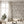 Exotica wallpaper by Victoria Sanders in cream, jungle animals and tropical flowers on a living room wall