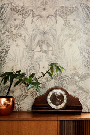Exotica wallpaper by Victoria Sanders in cream, jungle animals and tropical flowers above a sideboard