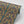 Plume wallpaper by Tatie Lou in navy and gold, partly unrolled roll showing Deco plumes