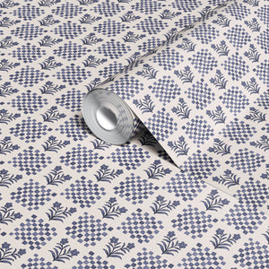 Picnic in the Flowers wallpaper by Studio Le Cocq in red, partly unrolled roll showing a small floral lattice