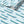 Swimming Sardines wallpaper by Seed Home Designs in blue, partly unrolled roll showing swimming sardines