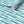 Swimming Sardines wallpaper by Seed Home Designs in turquoise, partly unrolled roll showing swimming sardines