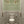 Clover Garden grasscloth by Dami and Em Design in light green, a trailing clover motif in a powder room
