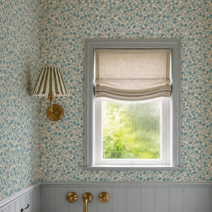 Annabelle wallpaper by Curate Space in teal, ditsy hand-painted florals in a powder room with a window and a basin