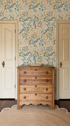 Eva wallpaper by Curate Space in off-white, a large-scale painterly floral in a hallway with a wooden chest of drawers