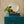 Eva wallpaper by Curate Space in soft green, a large-scale painterly floral behind a teal chest of drawers and round mirror