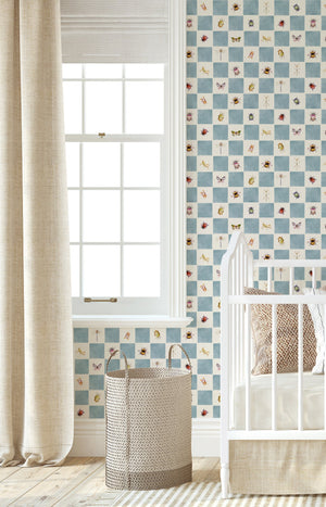 Jude wallpaper by Curate Space in blue, insects on a soft check in a nursery with a white cot
