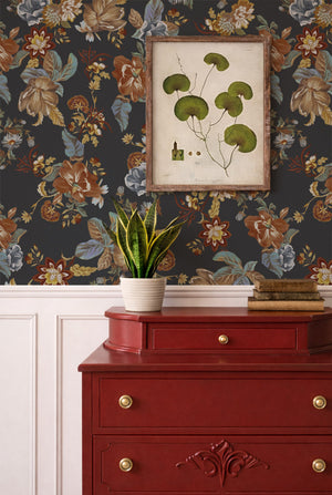 Lottie wallpaper by Curate Space in midnight blue, oversized chintz-style florals in a room with a red chest of drawers and a botanical print